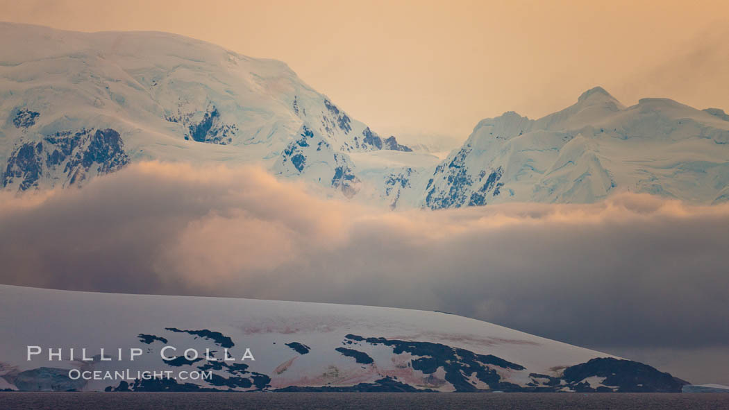 Scenery in Gerlache Strai.  Clouds, mountains, snow, and ocean, at sunset in the Gerlache Strait, Antarctica