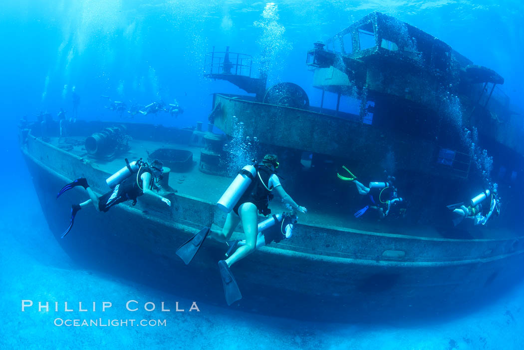 SCUBA divers on the wreck of the USS Kittiwake, sunk off Seven Mile Beach on Grand Cayman Island to form an underwater marine park and dive attraction. Cayman Islands, natural history stock photograph, photo id 32149