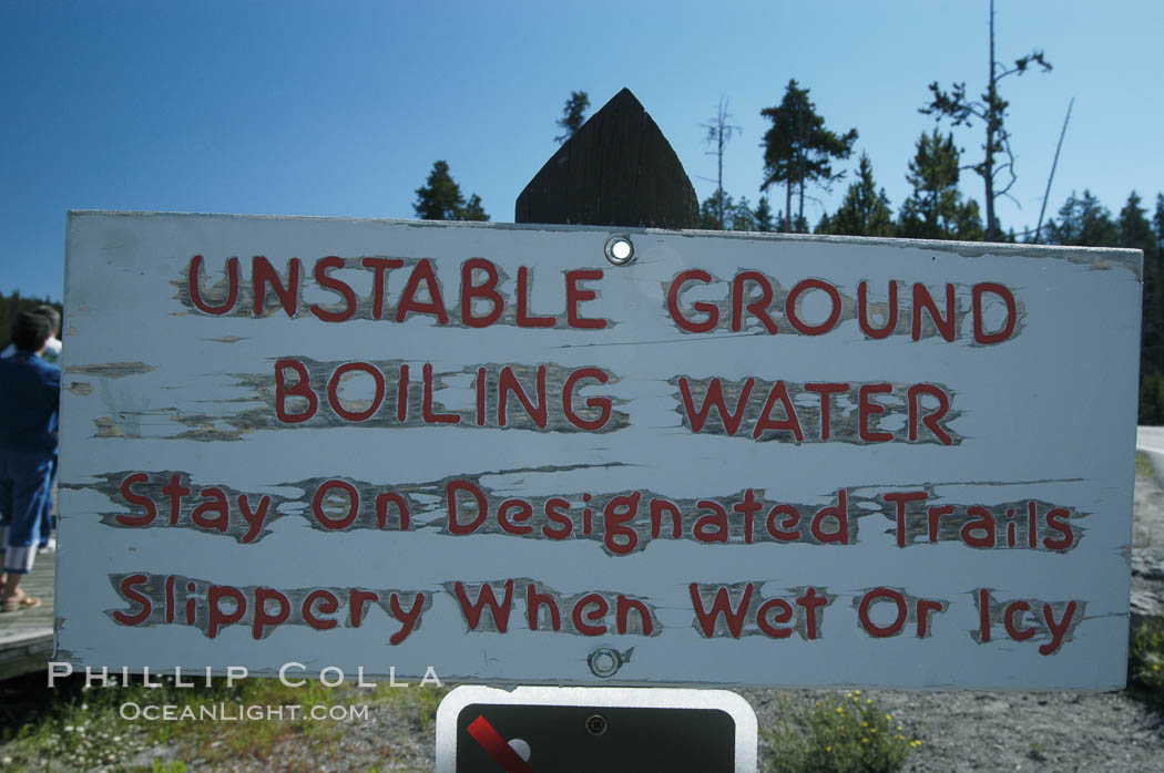 A sign warns Yellowstone visitors to beware of geysers, hot springs and superheated pools. Occasionally, park visitors are injured or killed falling into these dangerous geothermal features. Yellowstone National Park, Wyoming, USA, natural history stock photograph, photo id 07301