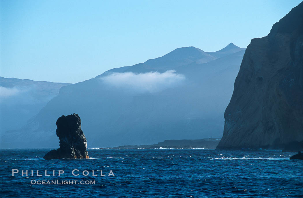 Skips Rock (left) with the west side of Guadalupe Island in the distance. Guadalupe Island (Isla Guadalupe), Baja California, Mexico, natural history stock photograph, photo id 06156
