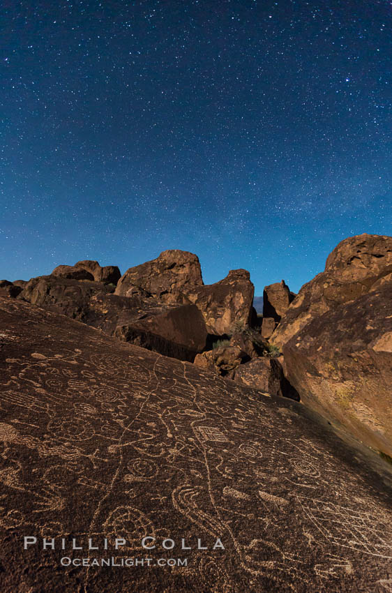 Sky Rock at night, light by moonlight with stars in the clear night sky above.  Sky Rock petroglyphs near Bishop, California. Hidden atop an enormous boulder in the Volcanic Tablelands lies Sky Rock, a set of petroglyphs that face the sky. These superb examples of native American petroglyph artwork are thought to be Paiute in origin, but little is known about them., natural history stock photograph, photo id 28499