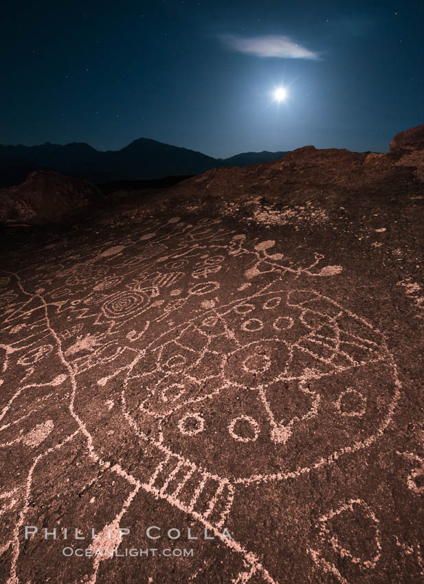 Sky Rock at night, light by moonlight with stars in the clear night sky above. Sky Rock petroglyphs near Bishop, California. Hidden atop an enormous boulder in the Volcanic Tablelands lies Sky Rock, a set of petroglyphs that face the sky. These superb examples of native American petroglyph artwork are thought to be Paiute in origin, but little is known about them