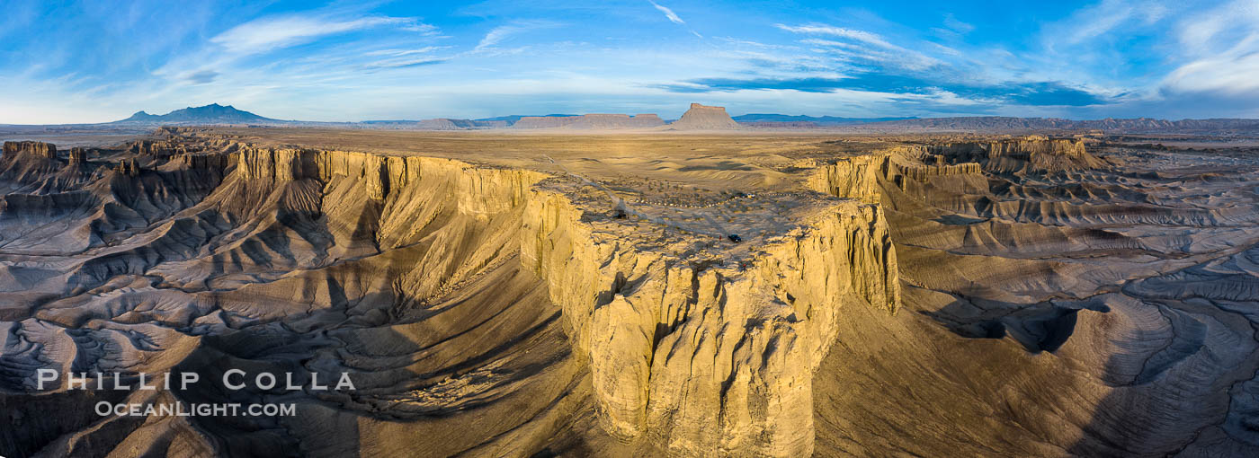 Skyline Rim promontory aerial panoramic photo, with Factory Butte in the distance. The Henry Mountains are in the far left.  The Blue Hills lie below the mesa.  Just after sunrise. Utah badlands., natural history stock photograph, photo id 38215