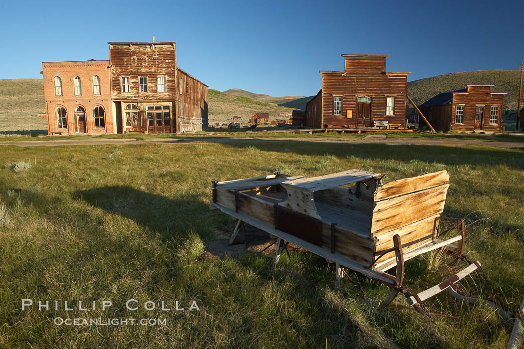 Sleigh, with Main Street buildings Dechambeau Hotel and I.O.O.F. Hall (left), Miners Union Hall and town morgue (right). Bodie State Historical Park, California, USA, natural history stock photograph, photo id 23143
