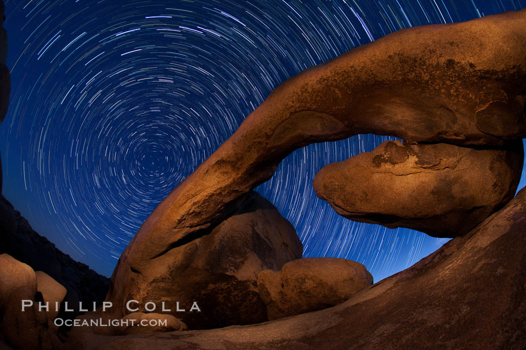 Star trails and Arch Rock. Polaris, the North Star, is at the center of the circular arc star trails as they pass above this natural stone archway in Joshua Tree National Park. Alabama Hills Recreational Area, California, USA, natural history stock photograph, photo id 27708