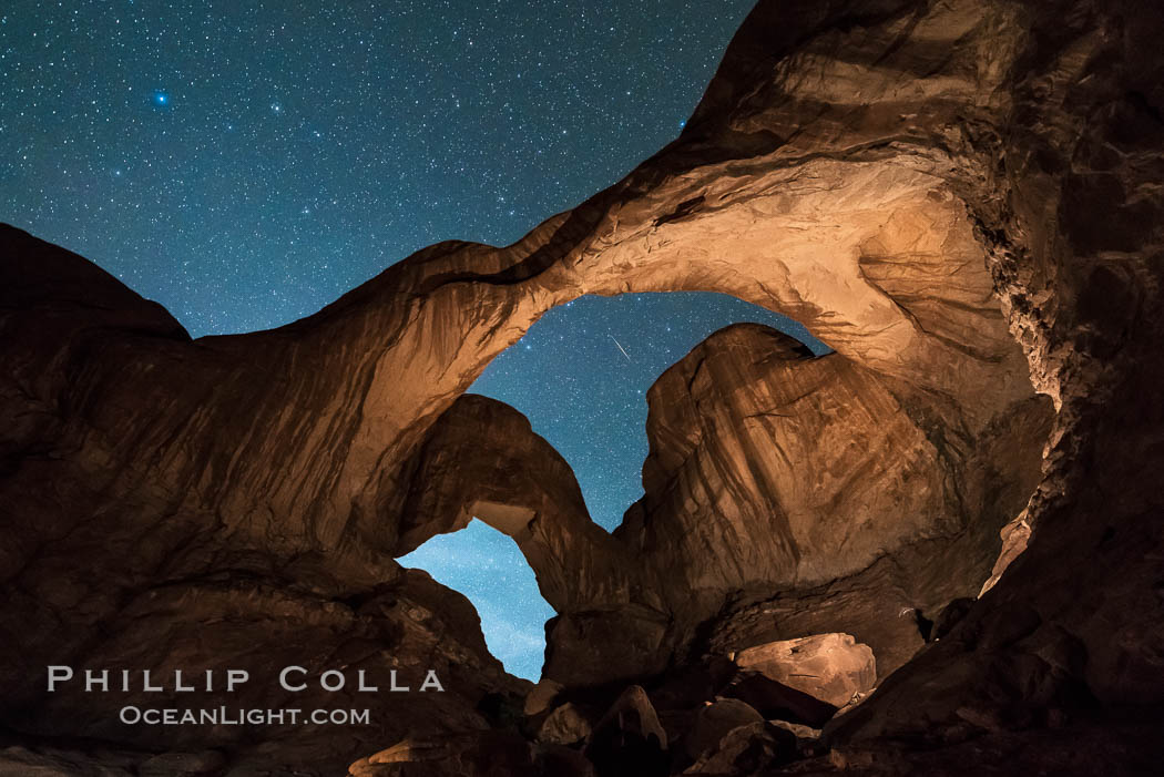 Stars and Iridium Flare over Double Arch, Arches National Park (Note: this image was created before a ban on light-painting in Arches National Park was put into effect.  Light-painting is no longer permitted in Arches National Park). Utah, USA, natural history stock photograph, photo id 29250