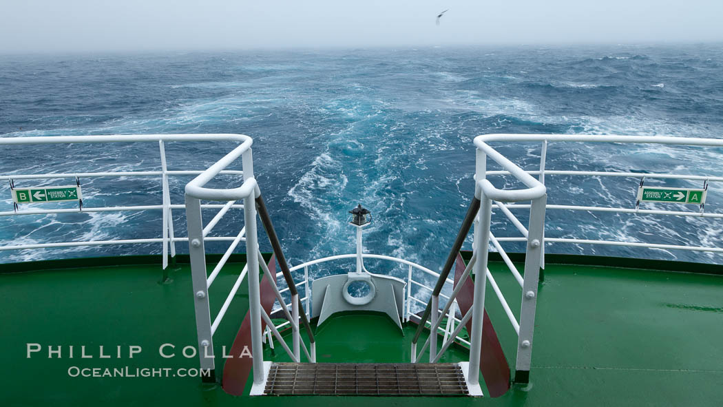 Stern of the M/V Polar Star, foggy weather, sea birds flying in the wake of the ship, at sea