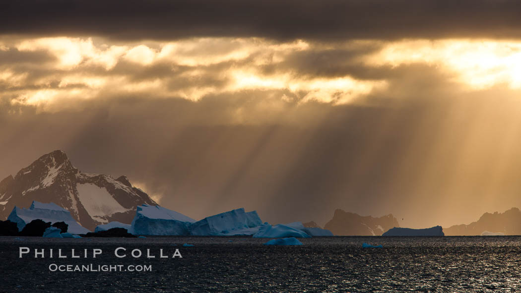 Iceberg, ocean, light and clouds.  Light plays over icebergs and the ocean near Coronation Island