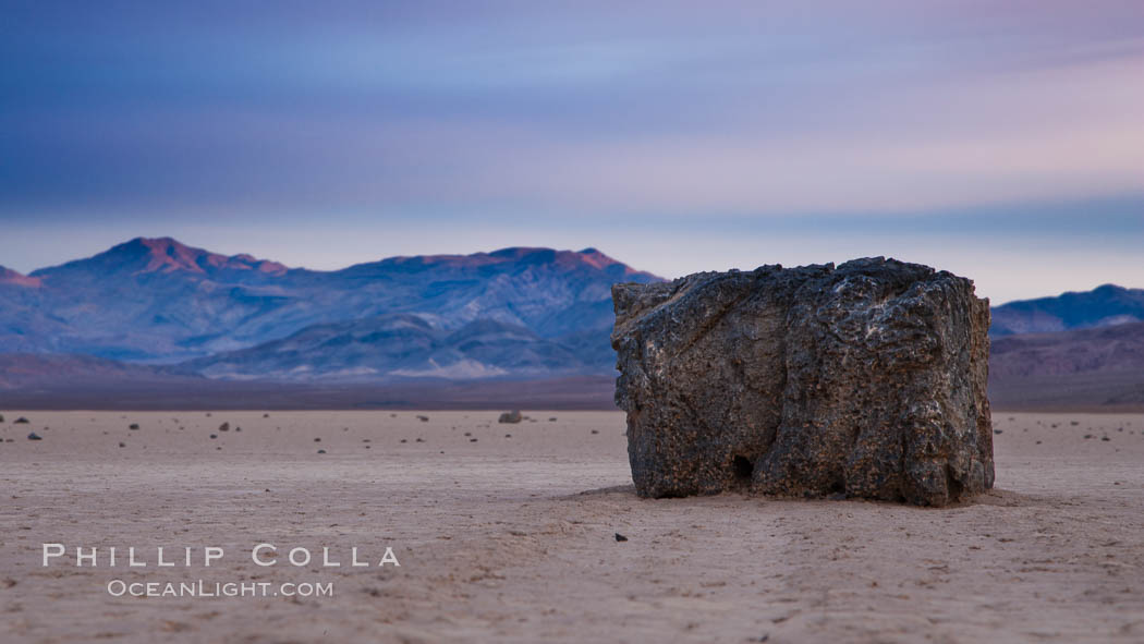 Sunrise on the Racetrack Playa. The sliding rocks, or sailing stones, move across the mud flats of the Racetrack Playa, leaving trails behind in the mud. The explanation for their movement is not known with certainty, but many believe wind pushes the rocks over wet and perhaps icy mud in winter. Death Valley National Park, California, USA, natural history stock photograph, photo id 27701