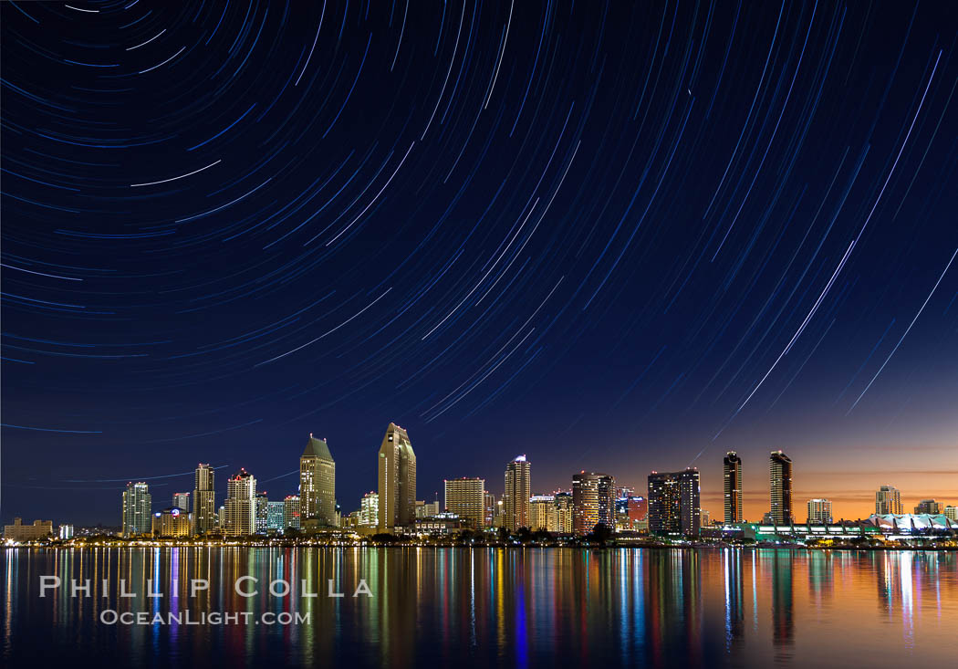 Approaching sunrise and star trails over the San Diego Downtown City Skyline. In this 60 minute exposure, stars create trails through the night sky over downtown San Diego