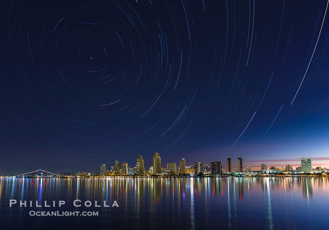 Approaching sunrise and star trails over the San Diego Downtown City Skyline.  In this 60 minute exposure, stars create trails through the night sky over downtown San Diego., natural history stock photograph, photo id 28387