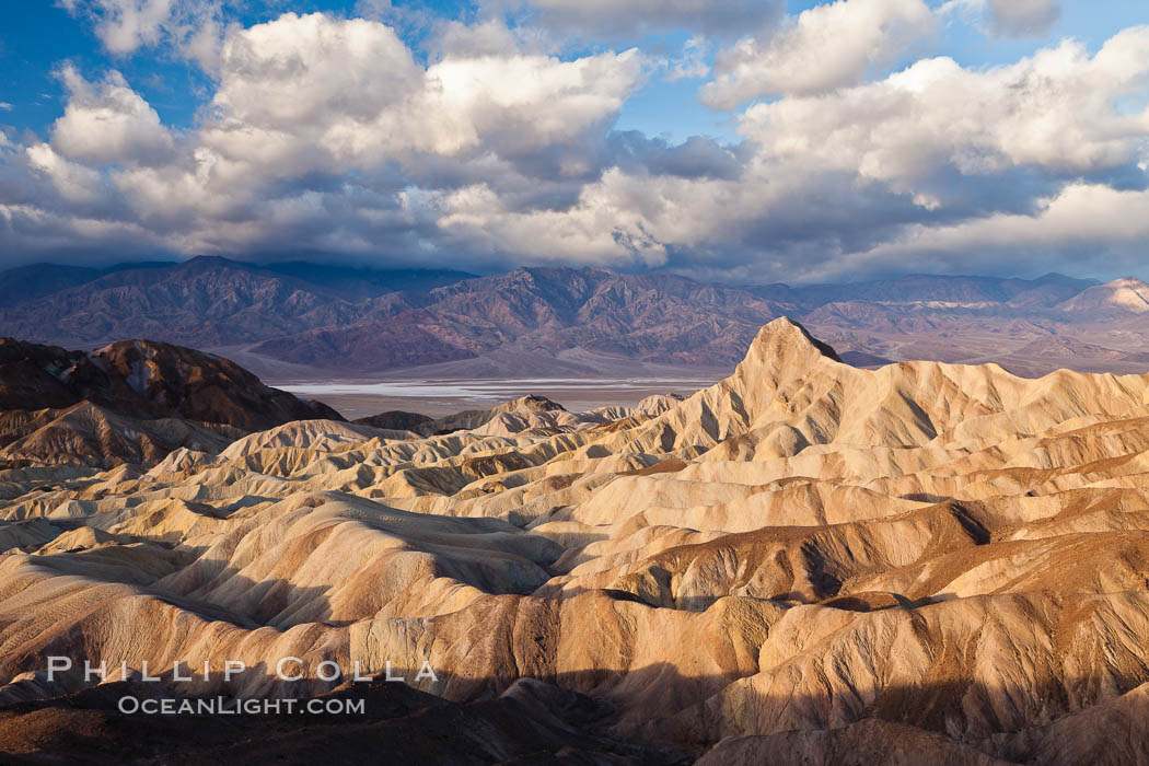 Sunrise at Zabriskie Point, Manly Beacon is lit by the morning sun while clouds from a clearing storm pass by. Death Valley National Park, California, USA, natural history stock photograph, photo id 27656