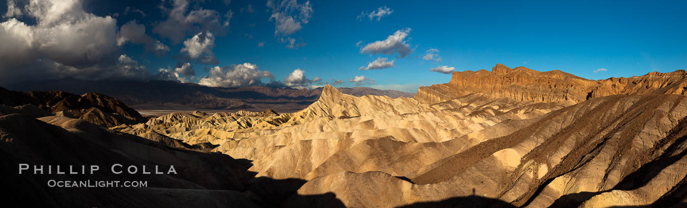 Sunrise at Zabriskie Point, Manly Beacon is lit by the morning sun while clouds from a clearing storm pass by. Death Valley National Park, California, USA, natural history stock photograph, photo id 27664