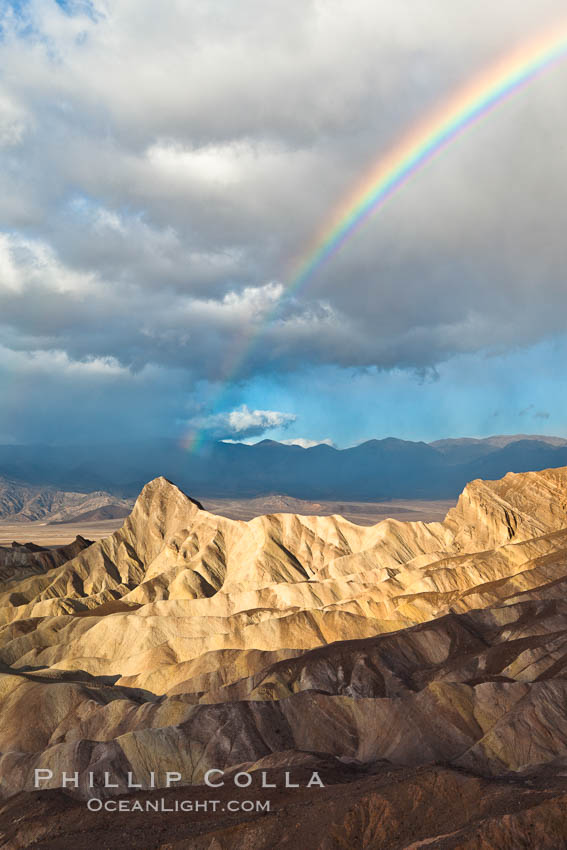 Sunrise at Zabriskie Point, Manly Beacon is lit by the morning sun while clouds from a clearing storm pass by. Death Valley National Park, California, USA, natural history stock photograph, photo id 27661