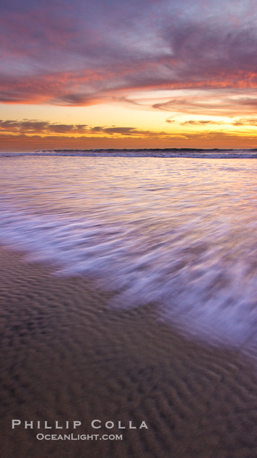 Sunset and incoming surf, gorgeous colors in the sky and on the ocean at dusk, the incoming waves are blurred in this long exposure., natural history stock photograph, photo id 27154