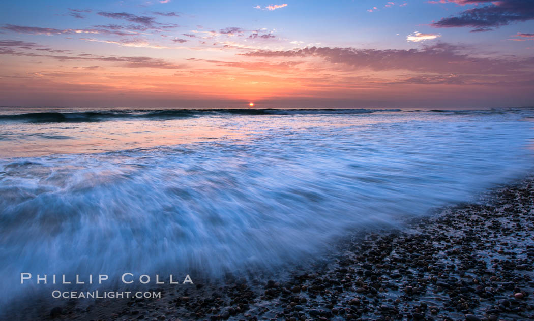 Sunset and incoming surf, gorgeous colors in the sky and on the ocean at dusk, the incoming waves are blurred in this long exposure, Carlsbad, California