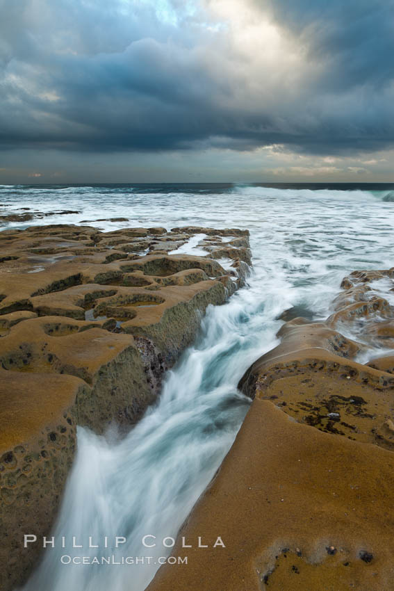Waves wash over sandstone reef, clouds and sky. La Jolla, California, USA, natural history stock photograph, photo id 26338