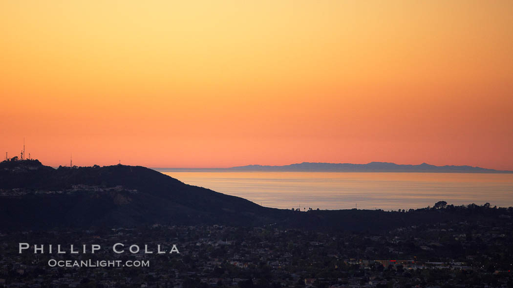 Mount Soledad juxtaposed against a distant San Clemente Island at sunset, San Diego, California