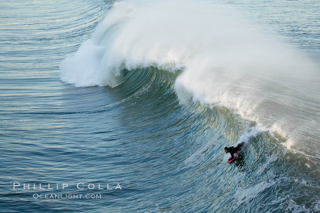 Bodyboarders tackle big waves at Oceanside Pier, sunset. Giant surf and big waves nail Southern California, December 21, 2005. USA, natural history stock photograph, photo id 14843