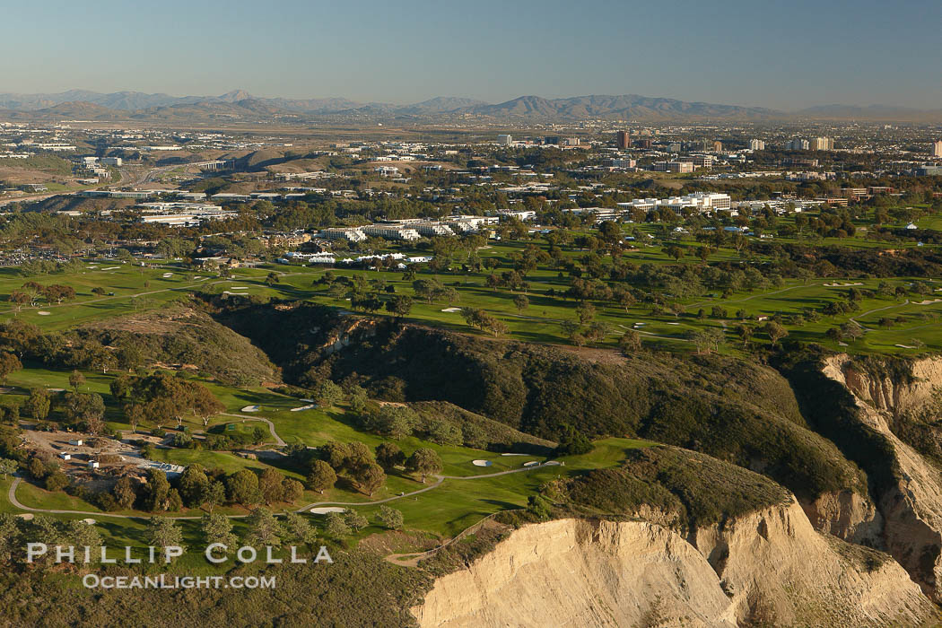 Torrey Pines golf course, situated atop the magnificent 300 foot tall seacliffs, offers majestic views of the Pacific Ocean south to La Jolla.  Scattered around the course are found Torrey pine trees, one of the rare species of pines in the world.  Some of La Jolla's biotechnology companies are seen on the far side of the golf course, along North Torrey Pines Road., natural history stock photograph, photo id 22418