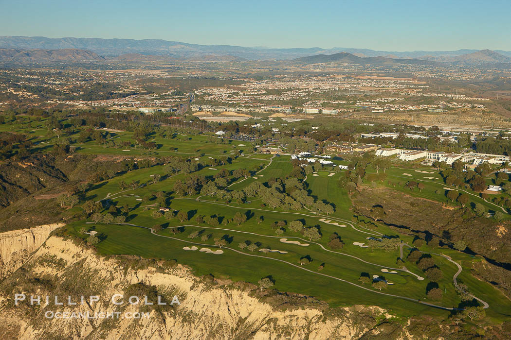Torrey Pines golf course, situated atop the magnificent 300 foot tall seacliffs, offers majestic views of the Pacific Ocean south to La Jolla.  Scattered around the course are found Torrey pine trees, one of the rare species of pines in the world.  Some of La Jolla's biotechnology companies are seen on the far side of the golf course, along North Torrey Pines Road., natural history stock photograph, photo id 22426