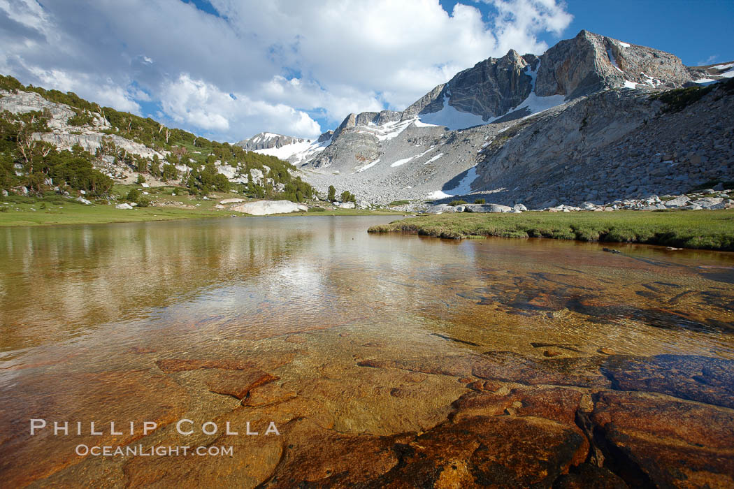 Townsley Lake (10396'), a beautiful alpine lake sitting below blue sky, clouds and Fletcher Peak (right), lies amid the Cathedral Range of glacier-sculpted granite peaks in Yosemite's high country, near Vogelsang High Sierra Camp, Yosemite National Park, California