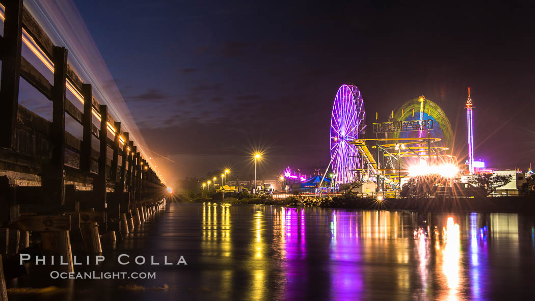 Train lights, Del Mar Fair and San Dieguito Lagoon at Night.  Lights from the San Diego Fair reflect in San Dieguito Lagooon, with the train track trestles to the left