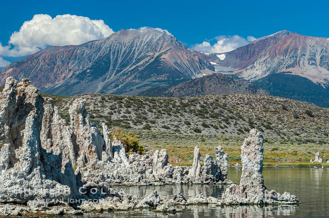 Tufa towers rise from Mono Lake with the Eastern Sierra visible in the distance. Tufa towers are formed when underwater springs rich in calcium mix with lakewater rich in carbonates, forming calcium carbonate (limestone) structures below the surface of the lake. The towers were eventually revealed when the water level in the lake was lowered starting in 1941. South tufa grove, Navy Beach