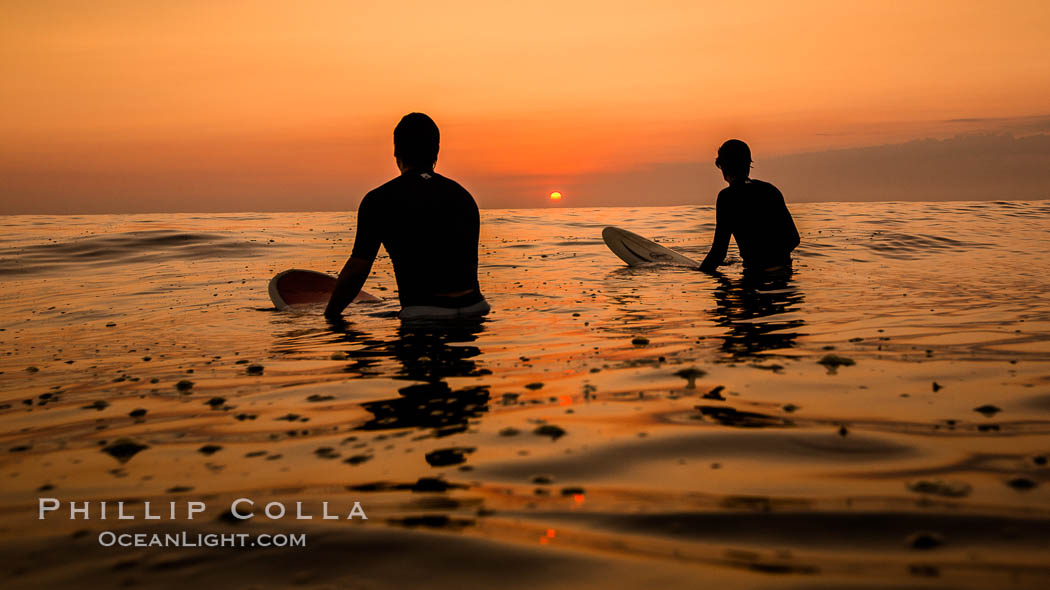Two surfers at sunset, blood red dusk, Encinitas. California, USA, natural history stock photograph, photo id 27976