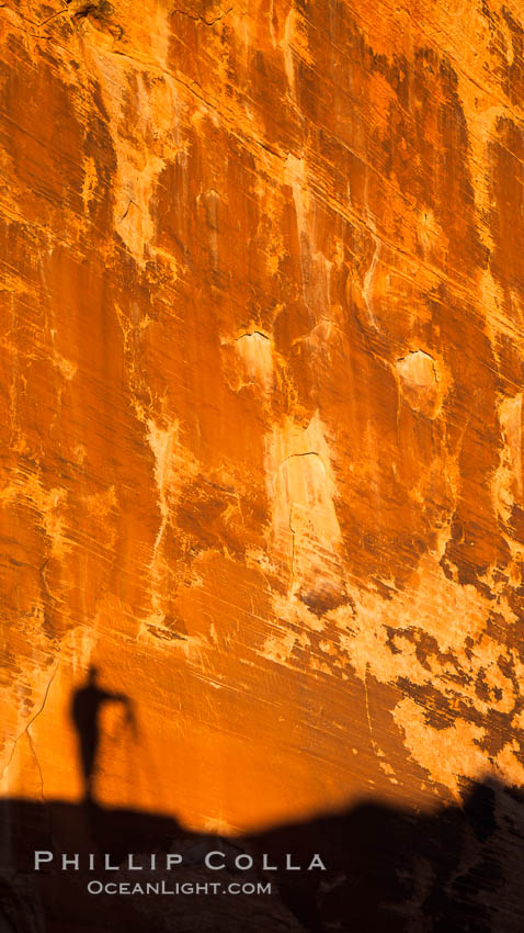 Rising sun creates the photographers shadow on a sandstone wall. Valley of Fire State Park, Nevada, USA, natural history stock photograph, photo id 26521