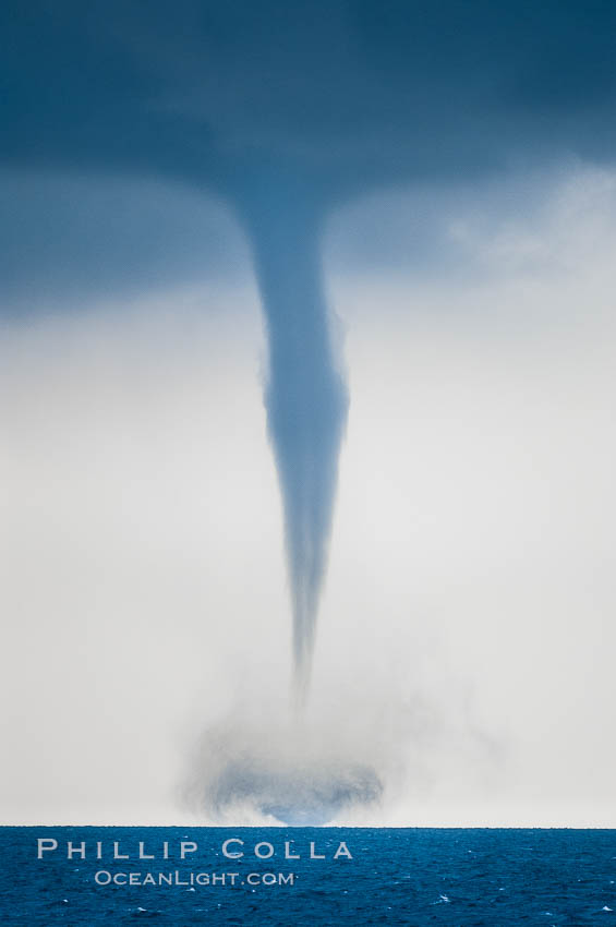 A mature waterspout, seen extending from clouds above to the ocean surface. A significant disturbance on the ocean is clearly visible, the waterspout has reached is maximum intensity. Waterspouts are tornadoes that form over water, Great Isaac Island