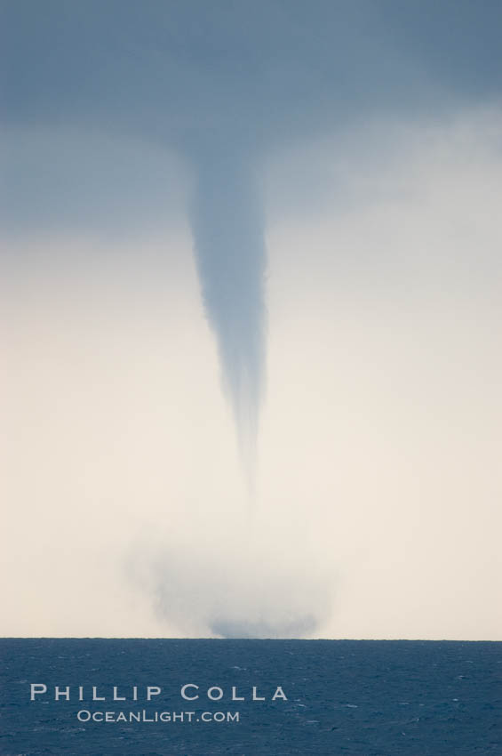 A mature waterspout, seen extending from clouds above to the ocean surface.  A significant disturbance on the ocean is clearly visible, the waterspout has reached is maximum intensity.   Waterspouts are tornadoes that form over water. Great Isaac Island, Bahamas, natural history stock photograph, photo id 10853