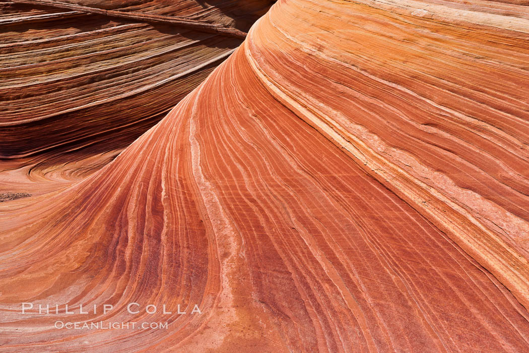 The Wave, an area of fantastic eroded sandstone featuring beautiful swirls, wild colors, countless striations, and bizarre shapes set amidst the dramatic surrounding North Coyote Buttes of Arizona and Utah.  The sandstone formations of the North Coyote Buttes, including the Wave, date from the Jurassic period. Managed by the Bureau of Land Management, the Wave is located in the Paria Canyon-Vermilion Cliffs Wilderness and is accessible on foot by permit only. USA, natural history stock photograph, photo id 20651