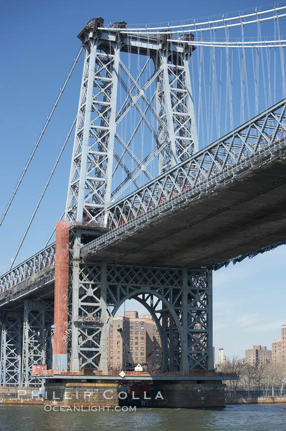 The Williamsburg Bridge viewed from the East River.  The Williamsburg Bridge is a suspension bridge in New York City across the East River connecting the Lower East Side of Manhattan at Delancey Street with the Williamsburg neighborhood of Brooklyn on Long Island at Broadway near the Brooklyn-Queens Expressway. USA, natural history stock photograph, photo id 11124