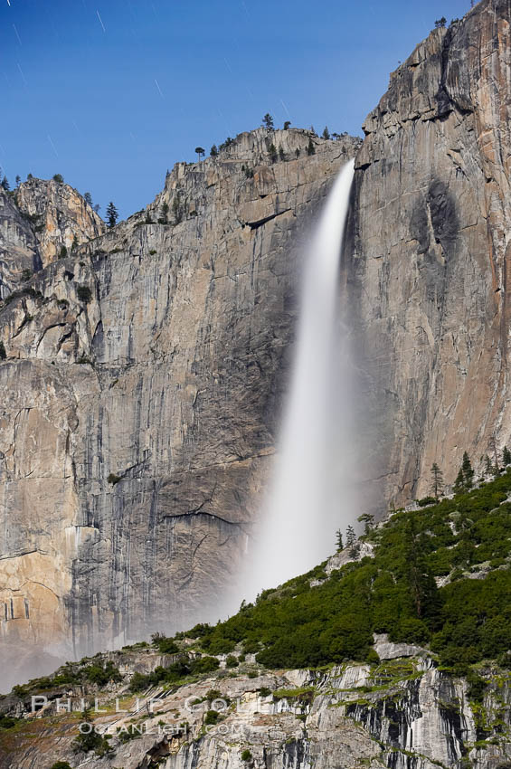 Upper Yosemite Falls by moonlight, viewed from Cooks Meadow. Star trails appear in the night sky. Yosemite Valley. Yosemite National Park, California, USA, natural history stock photograph, photo id 16098