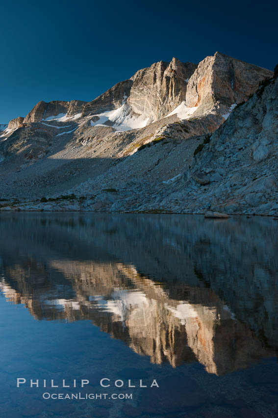 Cathedral Range peaks reflected in the still waters of Townsley Lake at sunrise, Yosemite National Park, California