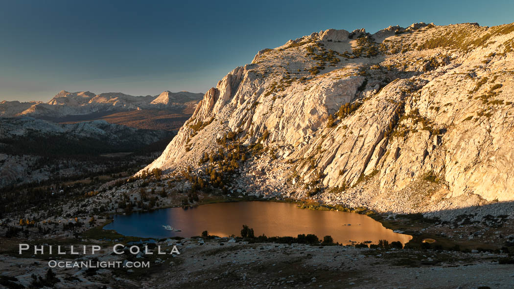 Fletcher Peak is reflected in Vogelsang Lake at sunset, viewed from near summit of Vogelsang Peak, Yosemite National Park, California