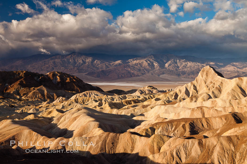 Sunrise at Zabriskie Point, Manly Beacon is lit by the morning sun while clouds from a clearing storm pass by. Death Valley National Park, California, USA, natural history stock photograph, photo id 27657