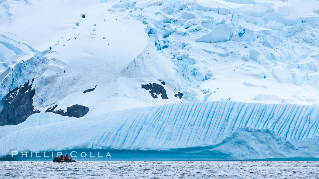 Zodiac cruising in Antarctica.  Tourists enjoy the pack ice and towering glaciers of Cierva Cove on the Antarctic Peninsula., natural history stock photograph, photo id 25562