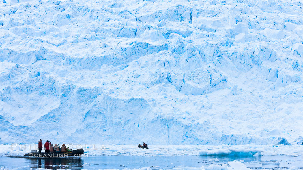 Zodiac cruising in Antarctica. Tourists enjoy the pack ice and towering glaciers of Cierva Cove on the Antarctic Peninsula