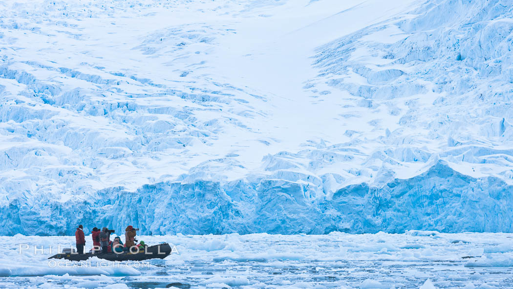 Zodiac cruising in Antarctica.  Tourists enjoy the pack ice and towering glaciers of Cierva Cove on the Antarctic Peninsula., natural history stock photograph, photo id 25529