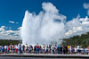 A crowd gathers to watch the worlds most famous geyser, Old Faithful, in Yellowstone National Park. Upper Geyser Basin, Wyoming, USA