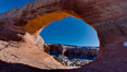 Wilson Arch rises high above route 191 in eastern Utah, with a span of 91 feet and a height of 46 feet. USA. Image #18035