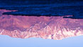 Sunrise lights Telescope Peak as it rises over the salt flats of Badwater, Death Valley.  At 11,049 feet, Telescope Peak is the highest peak in the Panamint Range as well as the highest point in Death Valley National Park.  At 282 feet below sea level, Badwater is the lowest point in North America. California, USA. Image #20550