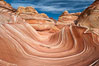 The Wave, an area of fantastic eroded sandstone featuring beautiful swirls, wild colors, countless striations, and bizarre shapes set amidst the dramatic surrounding North Coyote Buttes of Arizona and Utah.  The sandstone formations of the North Coyote Buttes, including the Wave, date from the Jurassic period. Managed by the Bureau of Land Management, the Wave is located in the Paria Canyon-Vermilion Cliffs Wilderness and is accessible on foot by permit only. USA. Image #20605