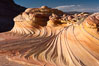 The Second Wave at sunset.  The Second Wave, a curiously-shaped sandstone swirl, takes on rich warm tones and dramatic shadowed textures at sunset.  Set in the North Coyote Buttes of Arizona and Utah, the Second Wave is characterized by striations revealing layers of sedimentary deposits, a visible historical record depicting eons of submarine geology. Paria Canyon-Vermilion Cliffs Wilderness, USA. Image #20606
