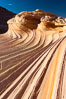 The Second Wave at sunset.  The Second Wave, a curiously-shaped sandstone swirl, takes on rich warm tones and dramatic shadowed textures at sunset.  Set in the North Coyote Buttes of Arizona and Utah, the Second Wave is characterized by striations revealing layers of sedimentary deposits, a visible historical record depicting eons of submarine geology. Paria Canyon-Vermilion Cliffs Wilderness, USA. Image #20613