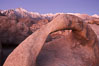 Mobius Arch, the Alabama Hills and the Sierra Nevada Range at sunrise, pink early morning light. Alabama Hills Recreational Area, California, USA. Image #21734