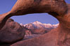 Mobius Arch at sunrise, framing snow dusted Lone Pine Peak and the Sierra Nevada Range in the background.  Also known as Galen's Arch, Mobius Arch is found in the Alabama Hills Recreational Area near Lone Pine. California, USA. Image #21736