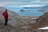 Hiker looks down on Stromness Harbour from the pass high above. South Georgia Island. Image #24582
